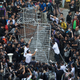 Building employees of the Citic Tower in Admiralty, the Umbrella Movement’s main protest site, remove barricades.